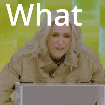 a woman is sitting in front of a laptop and the word what is above her head