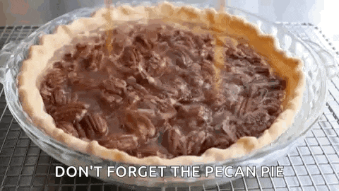 a pecan pie is sitting on a cooling rack with the words `` do n't forget the pecan pie '' .