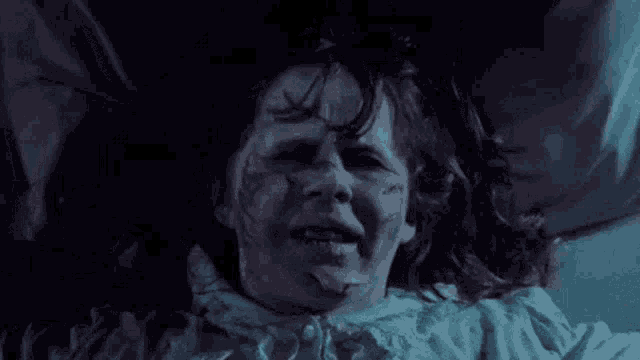 a close up of a person 's face with their eyes closed in a bed .