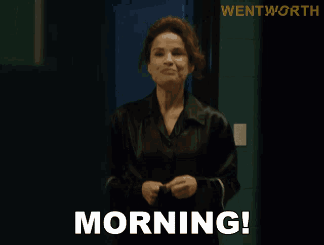 a woman standing in front of a door with the word morning written on it