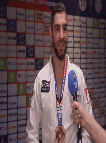 a man with a medal around his neck that says world judo championship