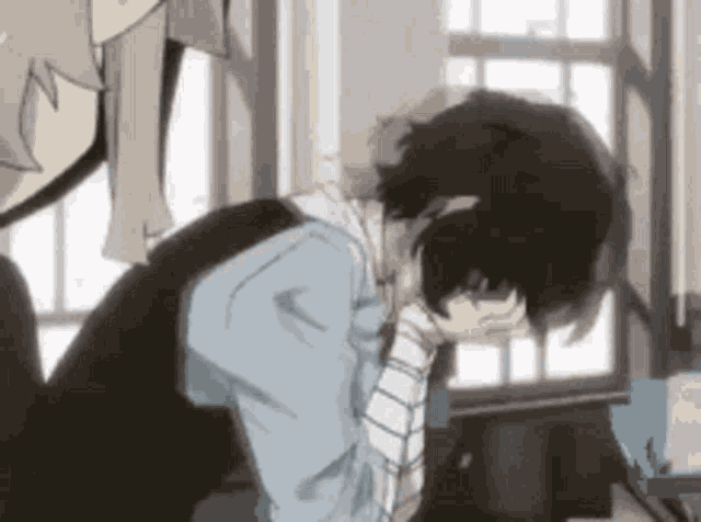 a man is kneeling down with his head in his hands in a room .