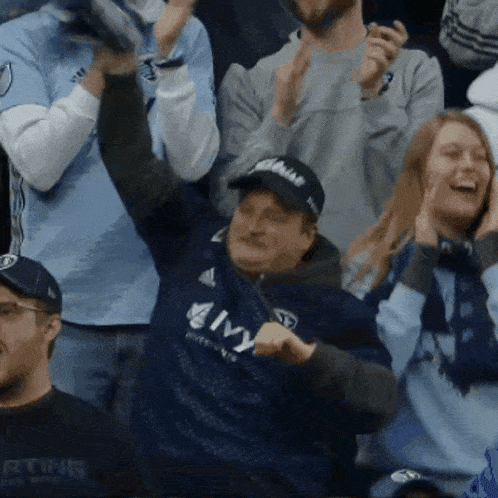 a man wearing a jersey that says amy is dancing in the crowd