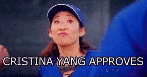 a woman wearing a baseball cap and a blue shirt is making a funny face .