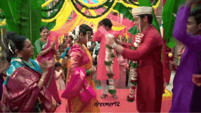 a bride and groom are dancing in front of a crowd at their wedding reception .