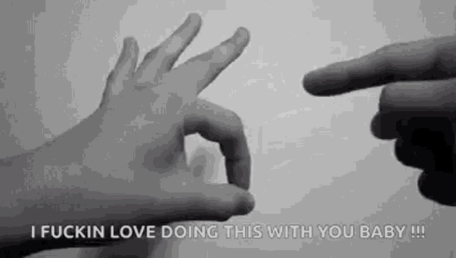 a black and white photo of two hands making the ok sign .