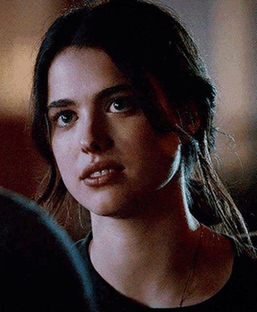 a close up of a woman 's face with dark hair