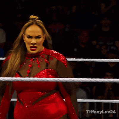 a woman in a red dress is standing in a boxing ring with the words tiffanyluv24 on the bottom