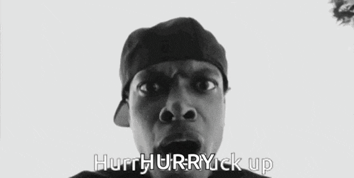 a black and white photo of a man with his mouth open and the words hurrhurrryuck up written below him