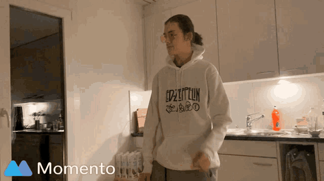 a person wearing a hoodie that says led zeppelin on it