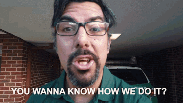 a man wearing glasses and a green shirt says you wanna know how we do it