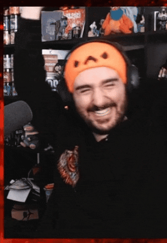 a man wearing headphones and a headband with a cat face on it