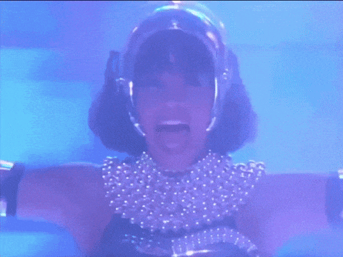 a woman wearing a helmet and pearls is screaming in the dark