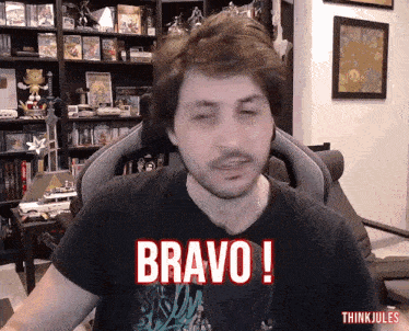 a man sitting in a chair with the word bravo written on his shirt