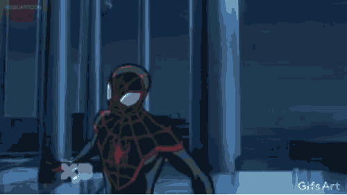 a spiderman is standing in front of a fireball in a room .