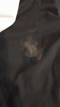 a blurred image of a person standing on a black surface
