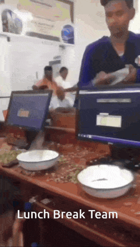 a man standing in front of a desk with bowls on it and the words lunch break team on the bottom