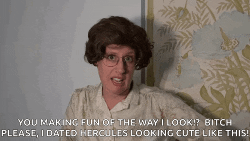 a woman in a wig and glasses says " you making fun of the way i look bitch please