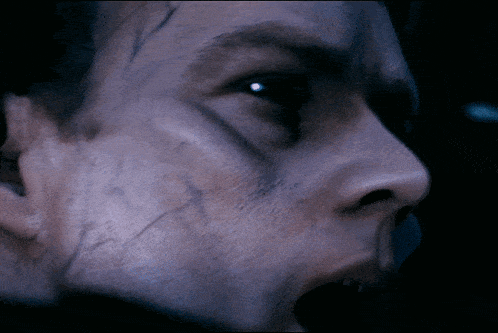 a close up of a man 's face with a scar on his forehead