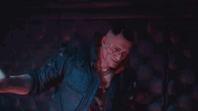 a man in a cyberpunk suit is holding a woman 's hand in a dark room .