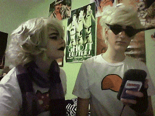 two people are standing in front of a poster that says ghost busters