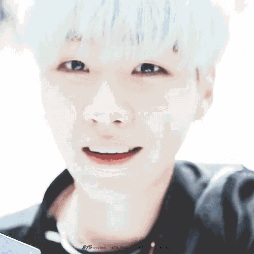 a close up of a person 's face with the name bts suga on the bottom
