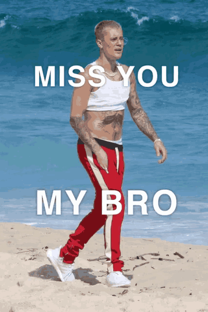 justin bieber walking on the beach with the words miss you my bro behind him