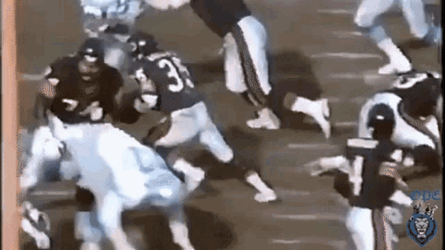 a group of football players are playing a game on a field . one of the players is wearing a number 33 jersey .