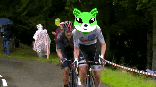 a man riding a bike with a green dog head on his head