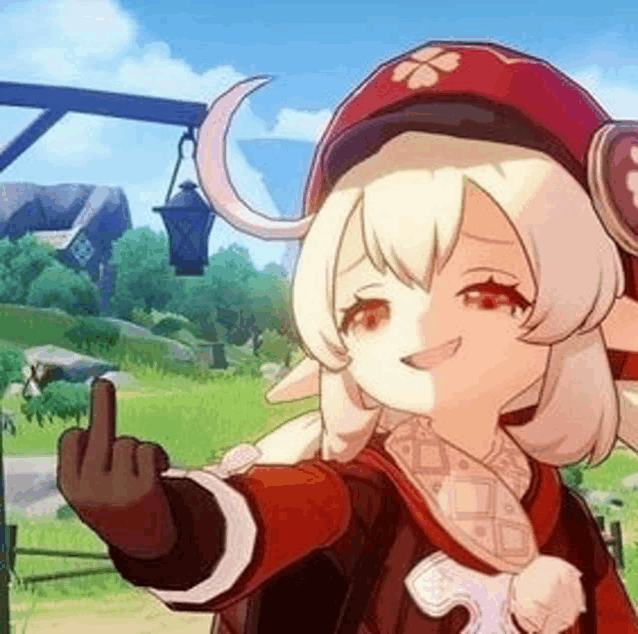 a girl in a red hat is giving the middle finger .