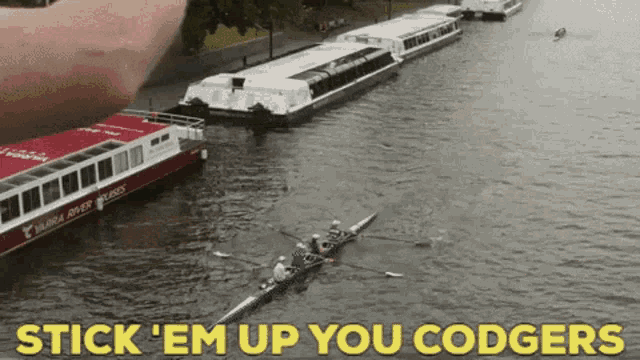 a group of people are rowing a boat on a river with the words stick ' em up you codgers