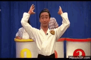 a man in a karate uniform is standing in front of three barrels with the letter a on them