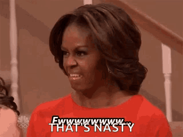 michelle obama is wearing a red dress and making a funny face .