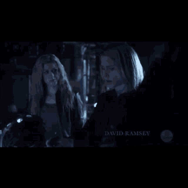 two women standing next to each other with the name emily bett rickards on the bottom right