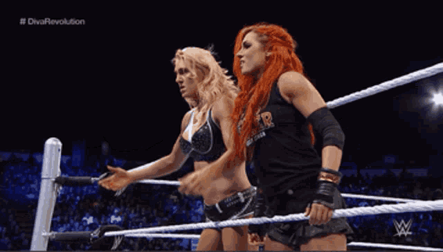 two women in a wrestling ring with the words diva revolution on the bottom right