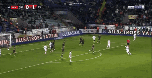 a soccer game is being played on a field with advertisements for allbatross yatirim
