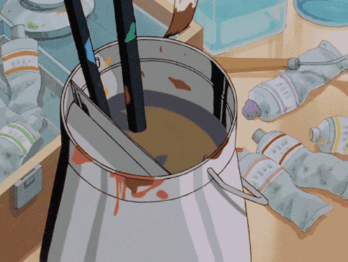 a bucket of paint sits on a table surrounded by bottles of paint