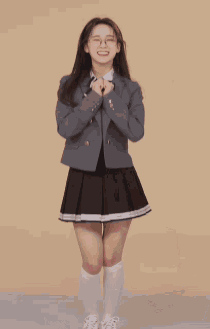 a girl in a school uniform holding a flower