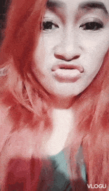a woman with red hair is making a funny face in a vlog