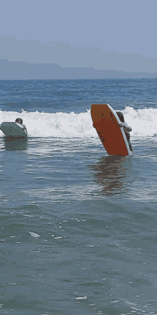 a woman in a bikini is surfing in the ocean
