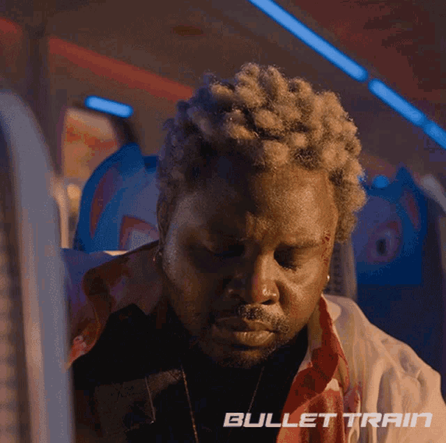 a man on a plane with bullet train written on the bottom of his face
