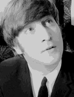 a close up of a man in a suit and tie looking up .