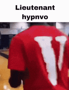 a person wearing a red shirt with the letter v on the back