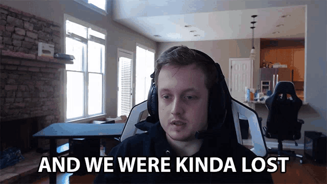a man wearing headphones says " and we were kinda lost " while sitting in a chair