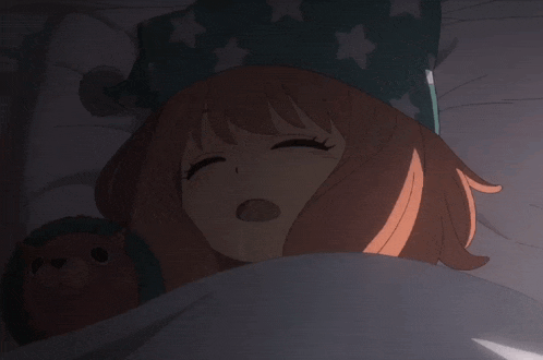 a girl sleeping in a bed with a stuffed animal