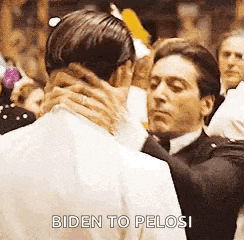 a man in a suit is hugging another man in a crowd .