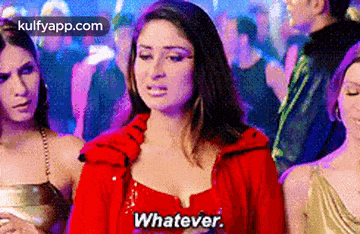 a woman in a red dress is standing in a crowd of people and saying whatever .
