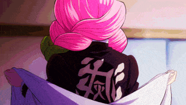 a woman with pink hair is wearing a jacket with chinese writing on it