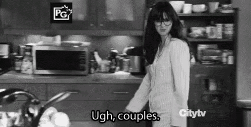 a black and white photo of a woman standing in a kitchen with the words `` ugh , couples . ''