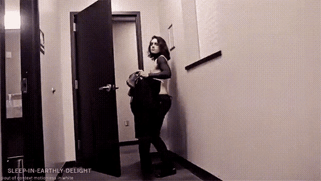 a woman is standing in a hallway with the words sleep-in-earthly-delight on the bottom right